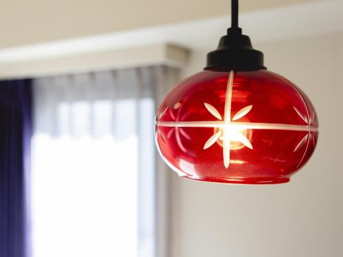 a red light bulb hanging from a ceiling at Hotel Wing International Select Ikebukuro in Tokyo
