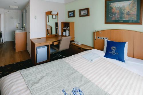 a hotel room with a large bed and a desk at Boston Plaza Kusatsu Biwa Lake - Vacation STAY 15431v in Kusatsu