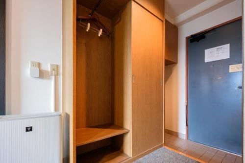 a room with a closet with a glass door at Miyazaki Mango Hotel - Vacation STAY 58252v in Miyazaki