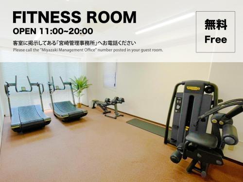 a fitness room with several treadmills and machines at Miyazaki Mango Hotel - Vacation STAY 58309v in Miyazaki