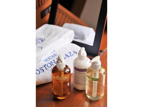a table with two bottles of medicine and a towel at Boston Plaza Kusatsu Biwa Lake - Vacation STAY 15436v in Kusatsu