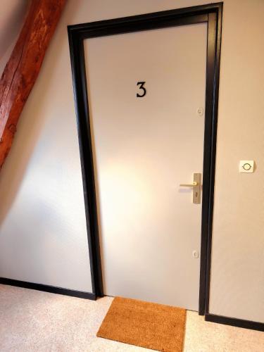 a door with the number on it in a room at Serenity Place in Beauvais