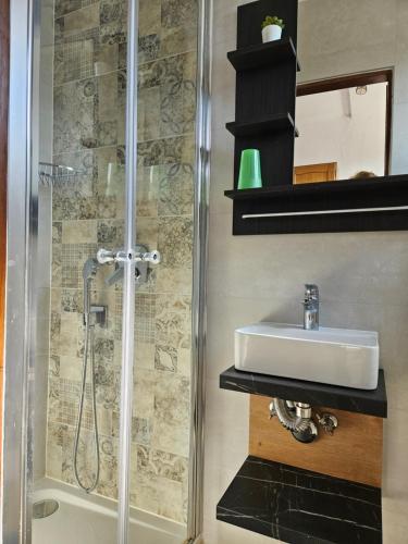 a bathroom with a sink and a shower at Bellavista bed and breakfast in Pag