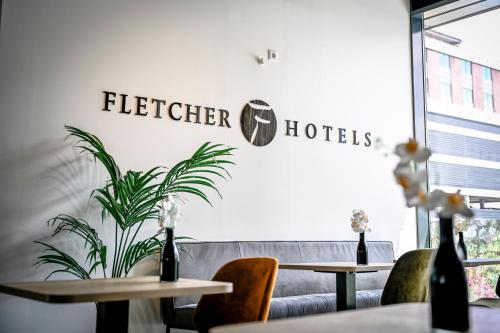 a restaurant with tables and chairs and a sign that reads better hotels at Fletcher Hotel Rotterdam-Airport in Rotterdam