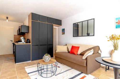 un salon avec un canapé et une table dans l'établissement L'Amoureux l Terrace & Parking l Shellter Rentals, à Saint-Tropez