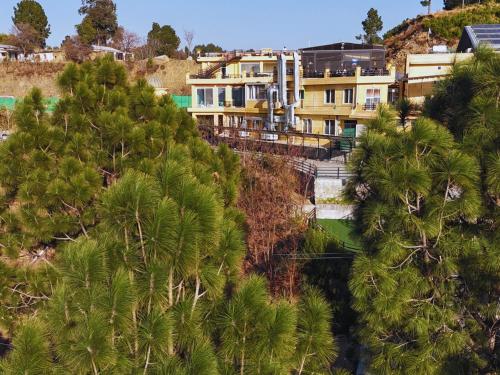 an aerial view of a resort with palm trees at Hidden Hills Hotel & Resort in Mānsehra