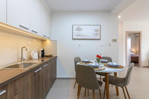a kitchen and dining room with a table and chairs at Respire modern house near sea in Gázion
