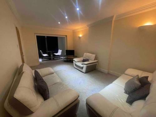 a living room with two beds and a couch at Charming House with Garden - Sleeps 6 & Parking in West Drayton