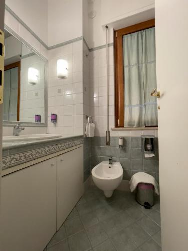 a bathroom with a sink and a toilet and a mirror at La Lanterna in Silvi Marina