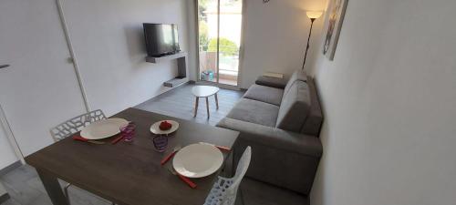 un salon avec un canapé et une table dans l'établissement Studio Cosy proche Carlone, balcon, à Nice