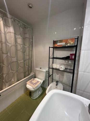 a bathroom with a toilet and a sink and a tub at Port Saplaya 2 habitaciones Valencia in Port Saplaya