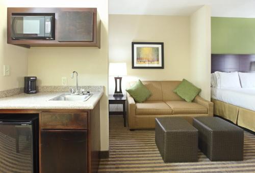 a hotel room with a bed and a sink and a couch at Holiday Inn Express & Suites Maumelle by IHG in Maumelle