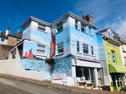 a building with a mural of a boat on it at Apters Hill House Dog Friendly With Free Parking in Brixham