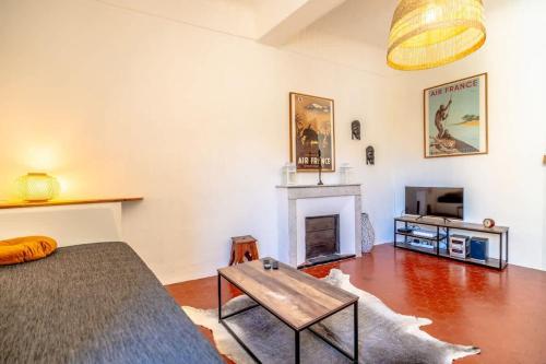 un salon avec un canapé et une cheminée dans l'établissement L'Ormeau l Historic St-Tropez l Shellter Rentals, à Saint-Tropez