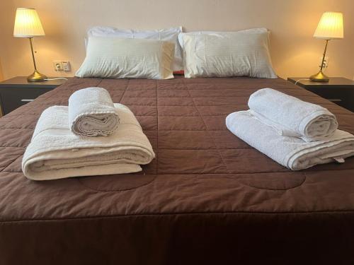 a bed with towels and pillows on top of it at Vacation Ηouse in Nea Plagia of Halkidiki, Greece in Nea Plagia