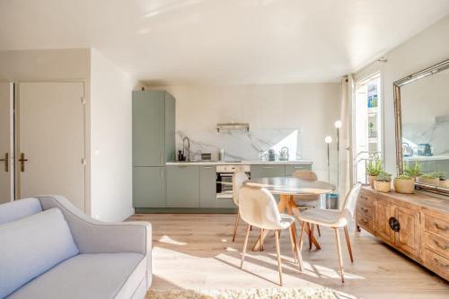 a living room with a table and chairs and a kitchen at Studio Roussel l Bright & AC l Shellter Rentals in Saint-Tropez