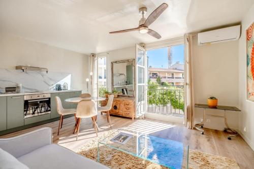 a living room with a couch and a table at Studio Roussel l Bright & AC l Shellter Rentals in Saint-Tropez