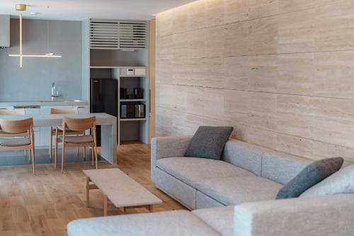 a living room with a couch and a dining room at Villa NIGIN in Miyazu