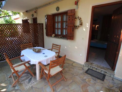 a table and chairs sitting on a patio at Andromahi Studios in Lefokastro