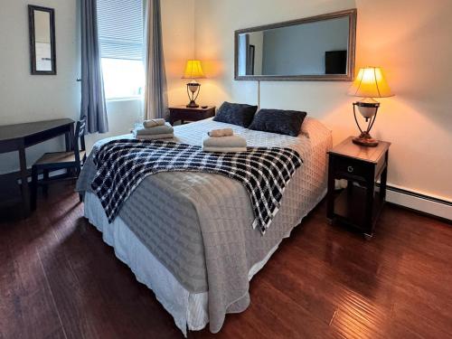 a bedroom with a bed with two towels on it at Mega Stunning Skyline View - APT 4-5 Combination - 6 Bedroom - Sleeps 25 - 15 mins to NYC in Union City