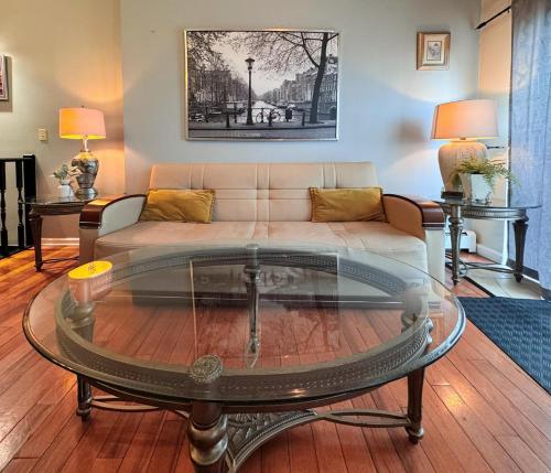 a living room with a couch and a coffee table at Mega Stunning Skyline View - APT 4-5 Combination - 6 Bedroom - Sleeps 25 - 15 mins to NYC in Union City