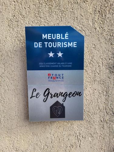 a book sitting on the side of a wall at Le Grangeon in Belley
