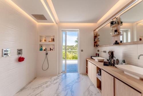 une salle de bain avec deux lavabos et une douche dans l'établissement Magnificent villa, heated pool, air cond, sea view, à Sainte-Maxime