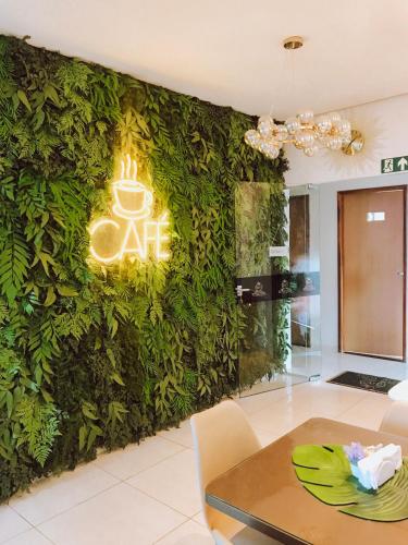 a living room with a wall covered in ivy at HOTEL VIANA in Barra do Corda