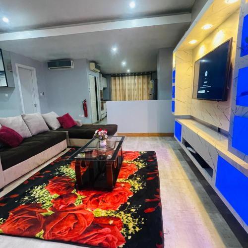 a living room with a couch and a table at Mus homes in Accra