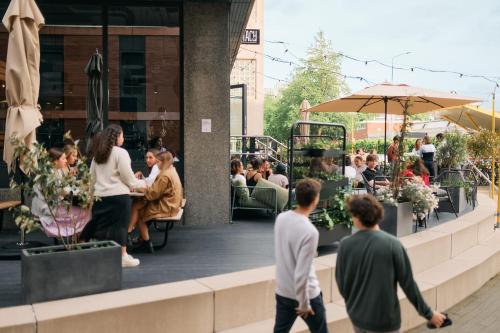 a group of people walking outside of a restaurant at The Social Hub Amsterdam West in Amsterdam