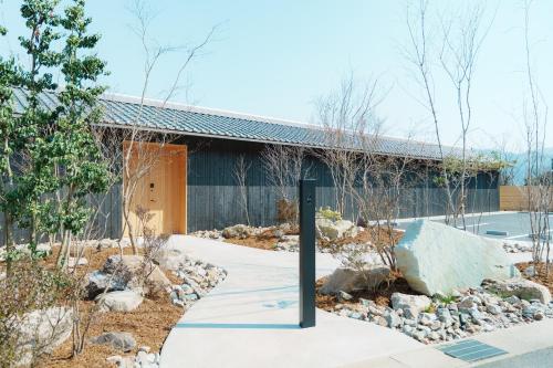 a building with a sign in front of it at Villa NIGIN in Miyazu