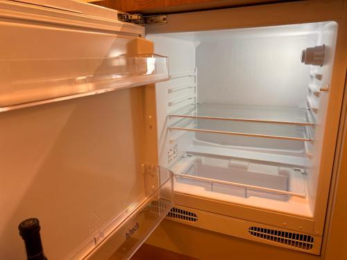 an empty refrigerator with its door open at Haus Lena Apartment 1 in Leopoldshagen