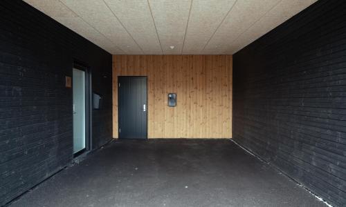 a hallway with a door and a brick wall at 3 BR Apartment - Parking - Sea View - Nature in Skálavík