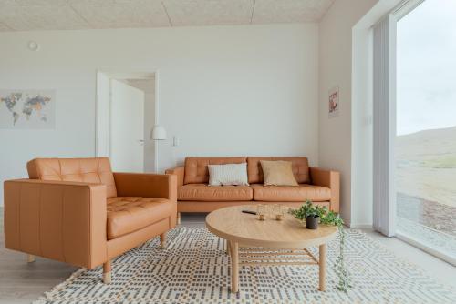 a living room with two couches and a coffee table at 3 BR Apartment - Parking - Sea View - Nature in Skálavík