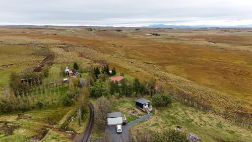 an aerial view of a farm with a truck on a road at Áshamrar in Hella