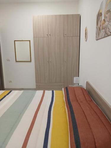 a bedroom with a bed and a cabinet in it at MaGa House in Catania