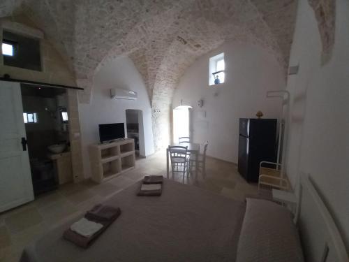 a large living room with a couch and a kitchen at Le Bianche Suites Ostuni in Ostuni
