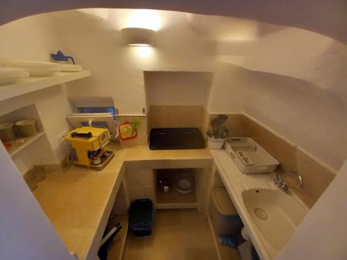 a small kitchen with a sink and a counter top at Le Bianche Suites Ostuni in Ostuni