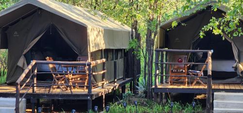 a group of chairs sitting inside of a tent at Tot Hier Toe in Phalaborwa