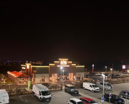 a parking lot with cars parked in front of a building at B&B HOTEL Montargis-Amilly in Amilly