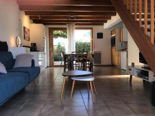 un salon avec un canapé, une table et des chaises dans l'établissement Gîte les oyats, à La Tranche-sur-Mer