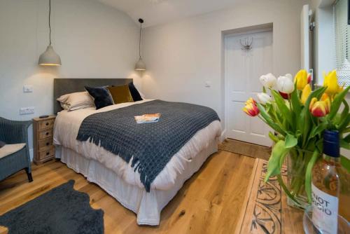 a bedroom with a bed and a vase of flowers at Scaw Fell in Cowes