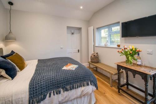 a bedroom with a bed and a tv on the wall at Scaw Fell in Cowes
