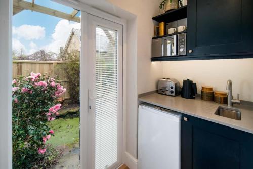 a kitchen with a sink and a counter with a window at Scaw Fell in Cowes