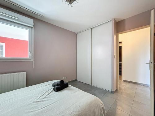 une chambre avec un lit et une fenêtre dans l'établissement Le Grand Chelem, Bel appartement secteur Ovalie, à Montpellier