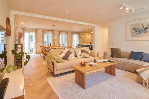 a living room with a couch and a table at Designer 2 BR Home with Private Balcony in Copenhagen