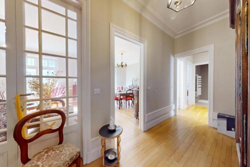 un salon avec une chaise et une grande fenêtre dans l'établissement 22 Rue de la Gare, à Annecy