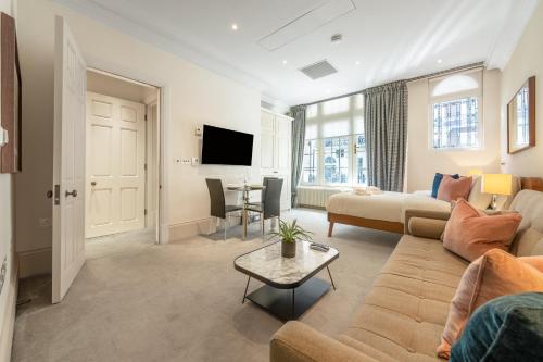 a living room with a couch and a table at The Mayfair Residence in London