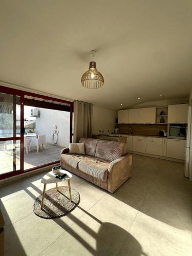 un grand salon avec un canapé et une table dans l'établissement F2 équipé Clim jardin Spa Centre Arles à 10mn, à Arles