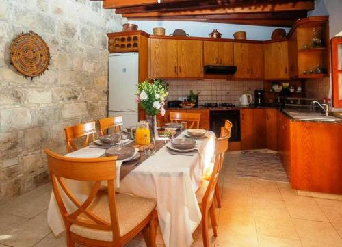 a kitchen with a table and chairs and a kitchen with a tableablish at HideAway Lasa in Lasa
